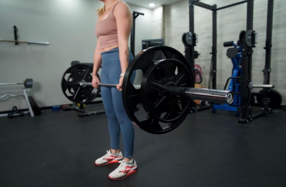 Side view as a woman lifts with the Major Fitness Barbell