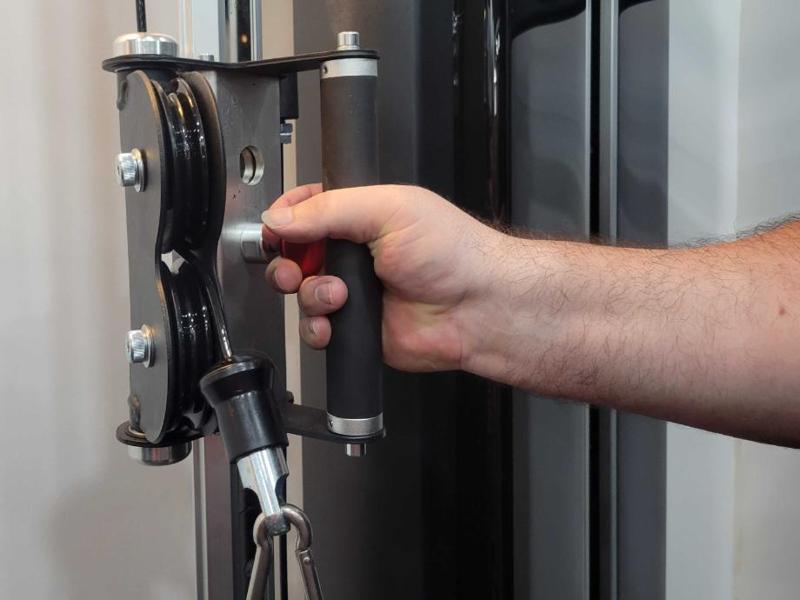 Our tester assessing the grip on the handles that come with the XMark Functional Trainer.