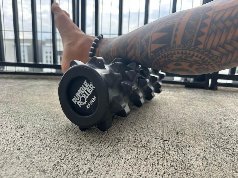 Our tester using a Rumble Roller on his calf.