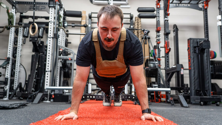 coop wearing a weighted vest in his garage gym