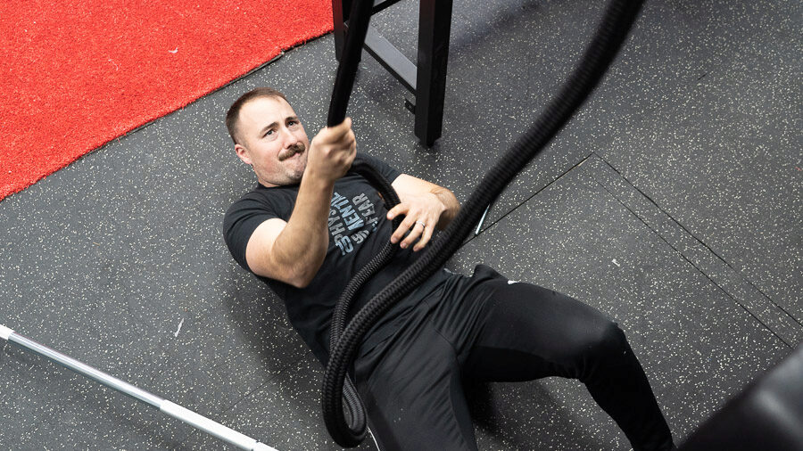 coop using Torque Endless Rope Trainer in his garage gym