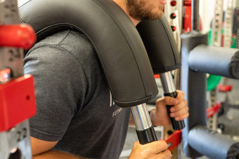 Photo showing the Marrs-Bar resting on a man's shoulders during a workout