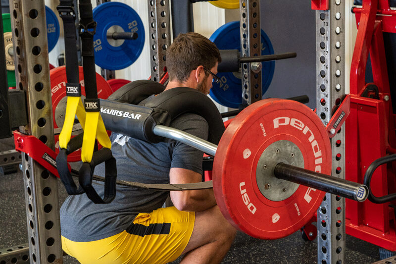 Man squatting with the Marrs Bar