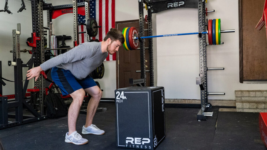 man using 24 inch Rep Fitness 3-in-1 Soft Plyo Box in a garage gym