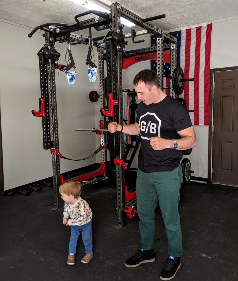 coop with his kid in his garage gym