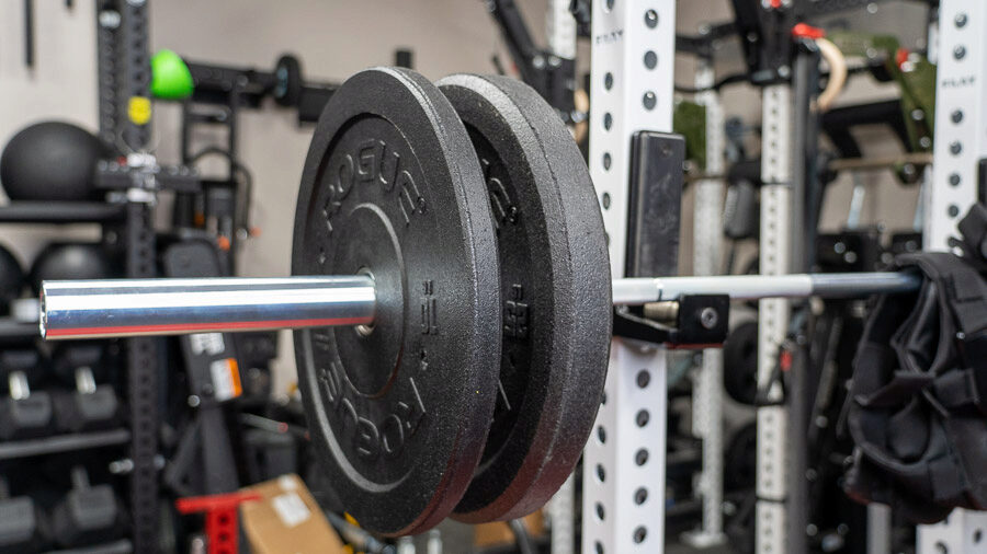 Some Rogue US MIL Spec Bumper Plates on a barbell in a rack