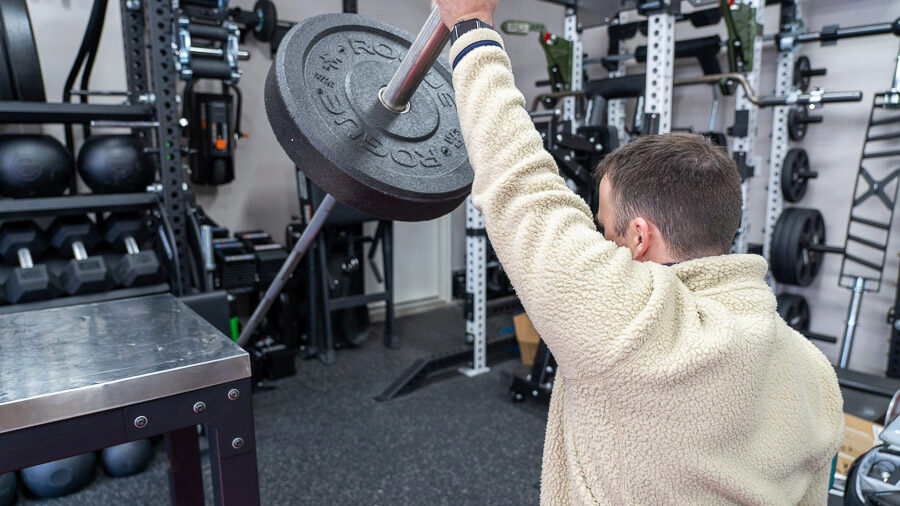 Coop using a Rogue US MIL Spec Bumper Plate on a barbell