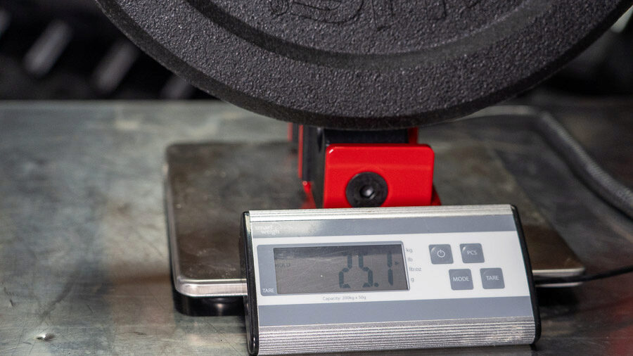 A scale showing the weight tolerance of a Rogue US MIL Spec Bumper Plate
