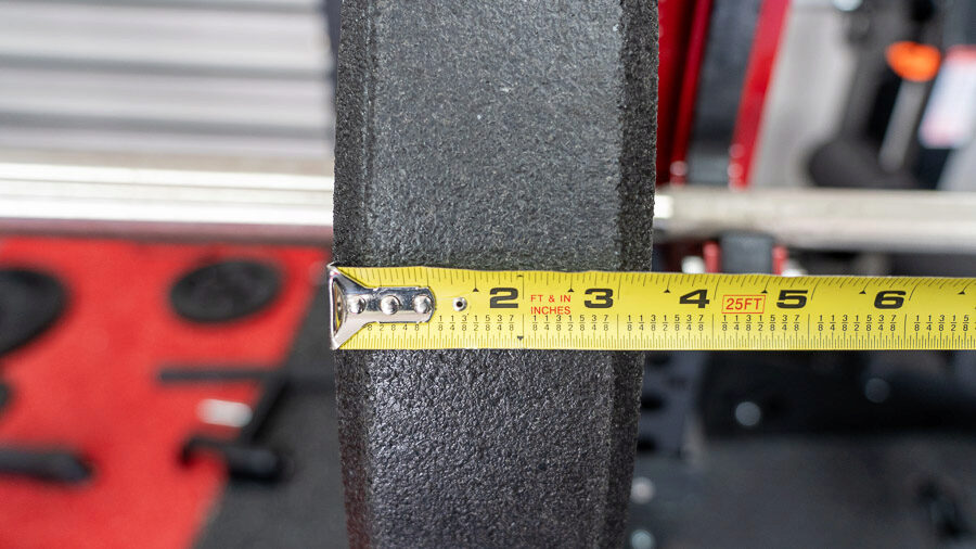 A measuring tape showing the width of a Rogue US MIL Spec Bumper Plate