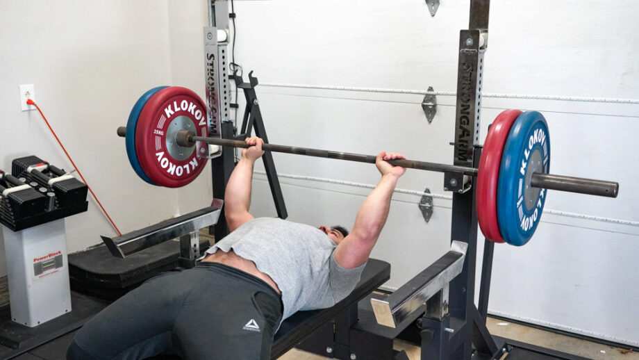 man performing a chest press with the StrongArm Sport Combo Rack