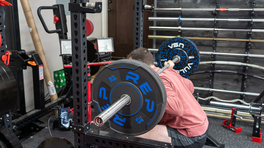 coop squatting with the REP Fitness Sport Bumper Plates