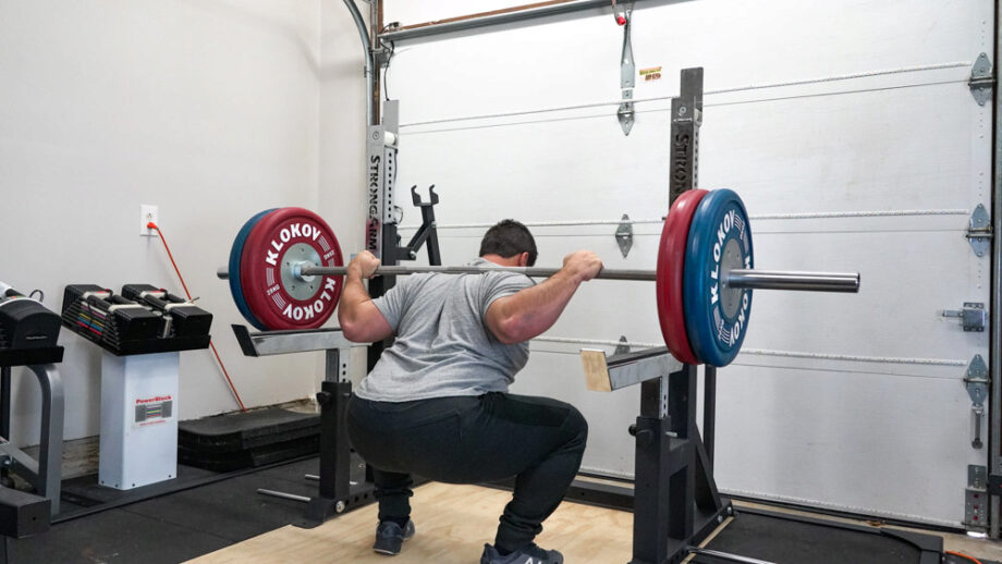 A man squatting with the Rogue Ohio Bar on his shoulders