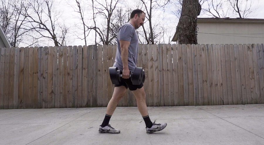 Coop doing farmers carries with the adjustable dumbbells. 