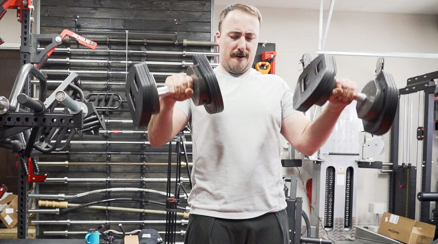 Coop using the adjustable dumbbells.