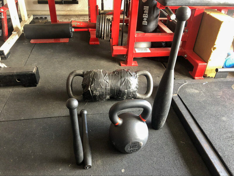 onnit  Steel Clubs and kettlebell in a garage gym