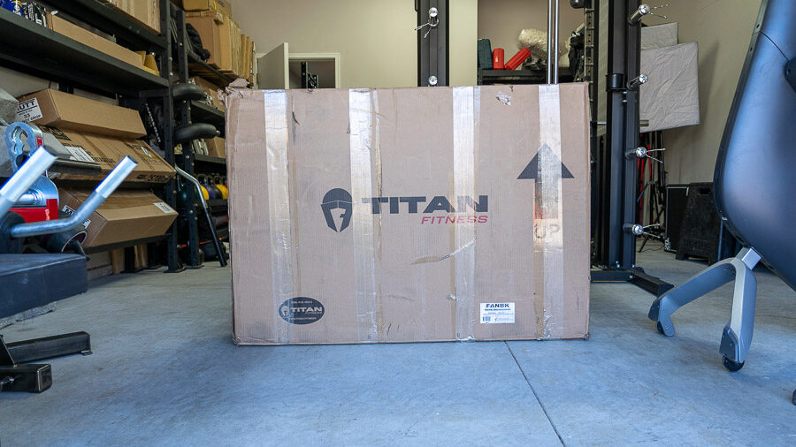 The large, brown cardboard box that the Titan Fitness Fan Bike came in.
