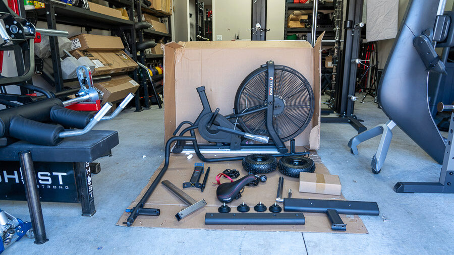 Everything has been unwrapped from the shipping box and lays on the garage gym floor. 