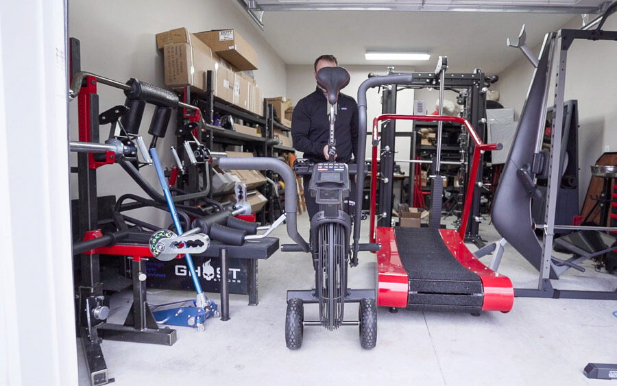 Coop wheeling the Titan Fan Bike inside his garage with the attached wheels.