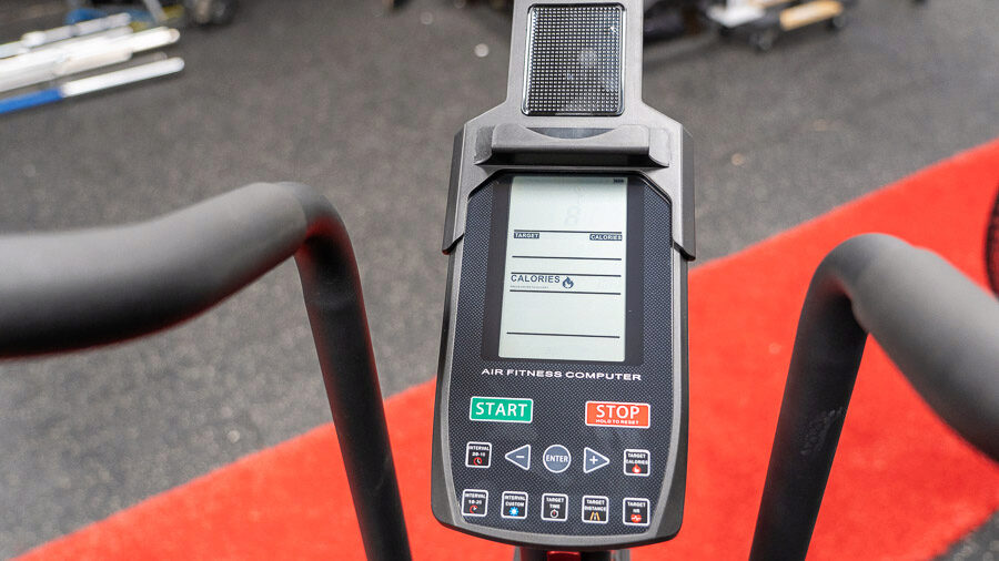 The basic LCD screen of the Titan Fitness Fan Bike is shown. You can see things like stop, start, enter, and target heart rate.