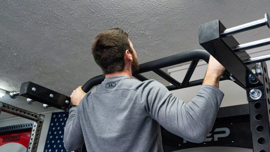 man performing pull ups on the Rep Fitness HR-5000 Half Rack