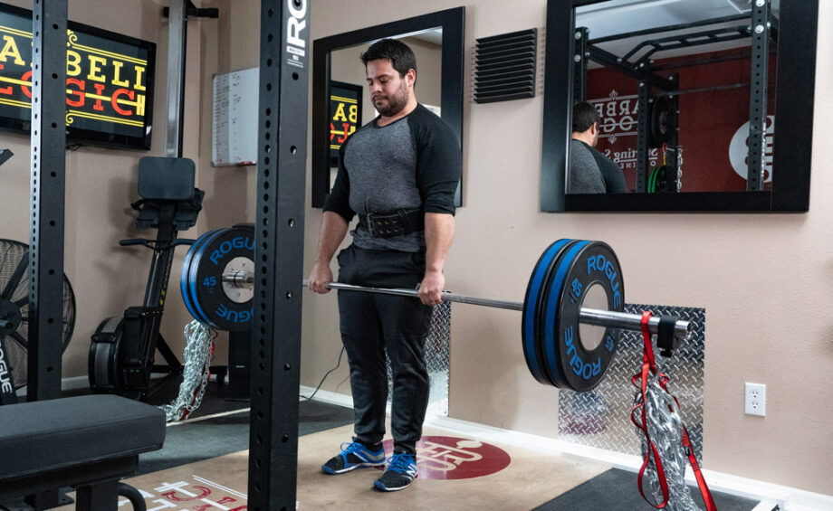 man performing a deadlift with the Pioneer Cut Powerlifting Belt