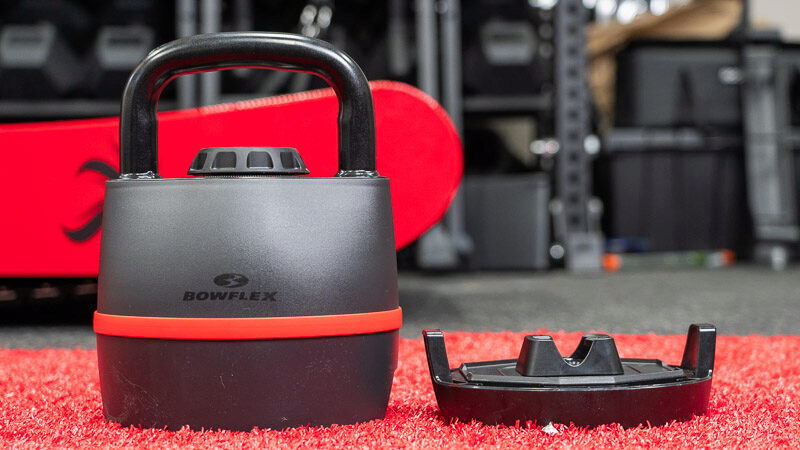 The Bowflex kettlebell is shown with the plastic stand that you can set the piece of equipment on. 