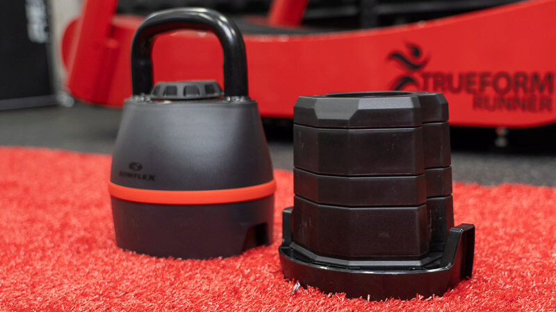 Bowflex kettlebell with the weight plates stacked next to it. 