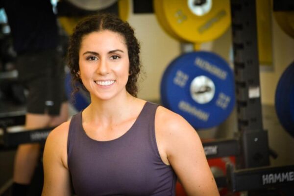 Amanda smiling in a gym