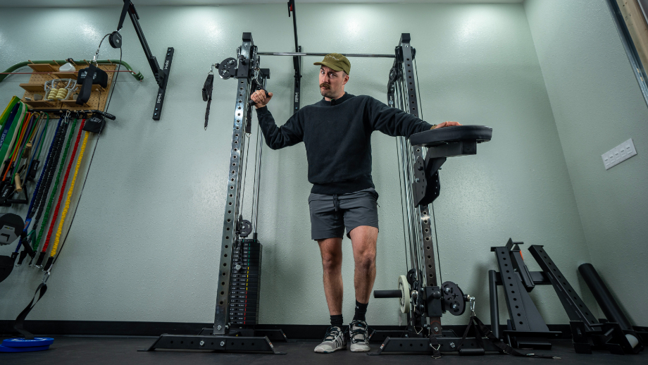 Professional woman athlete using the pulley machine Stock Photo by