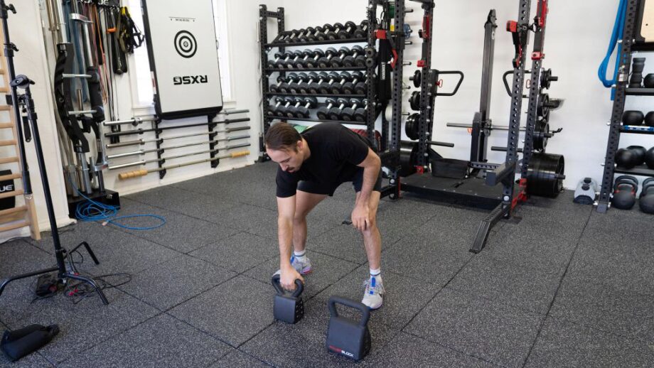 coop using dumbells in gym