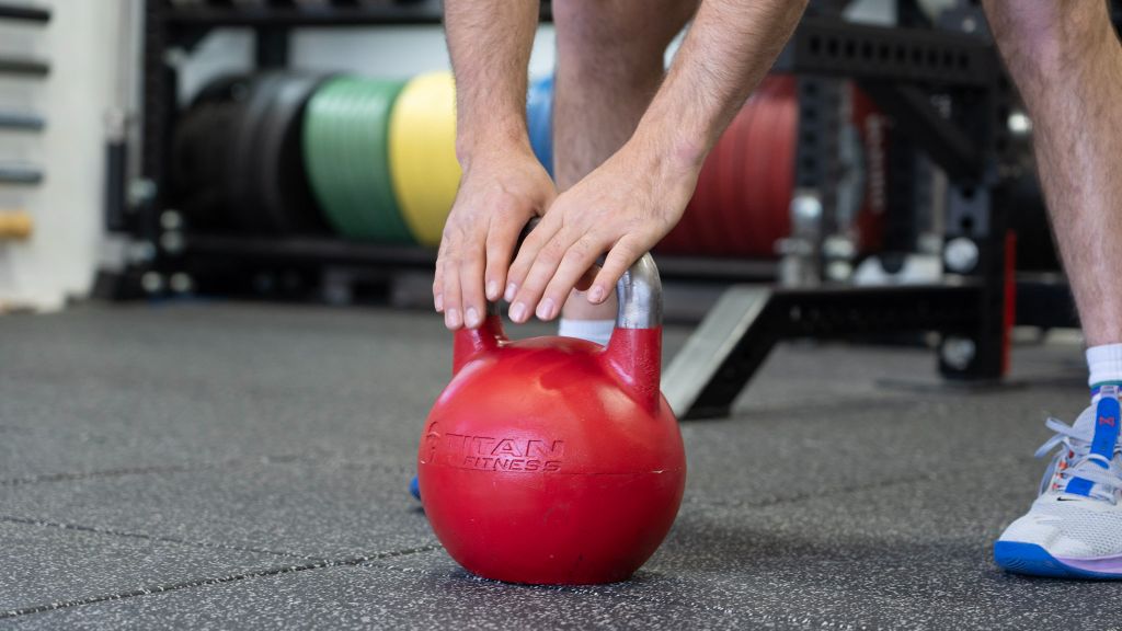 Coop grabbing Titan competition adjustable kettlebell