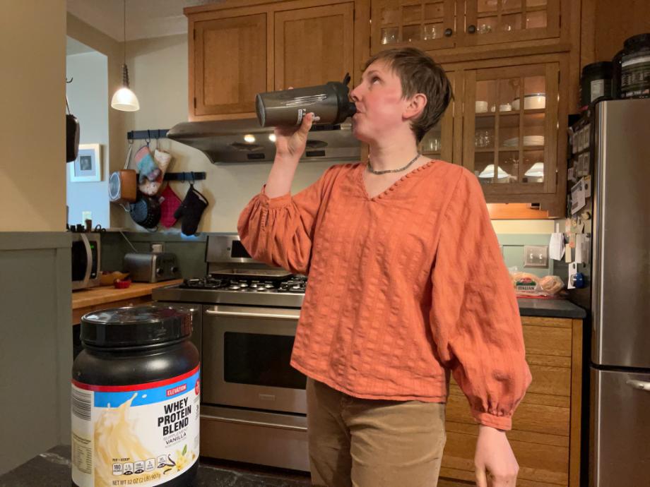 Woman drinking Elevation protein powder