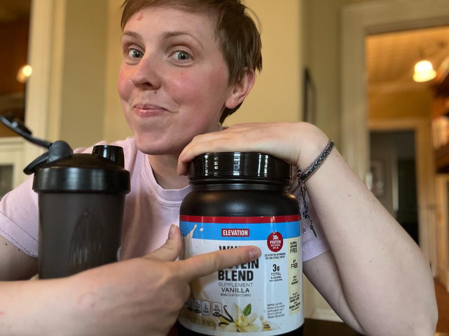 Woman pointing to Elevation protein powder content
