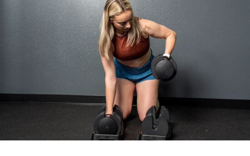 Flybird Adjustable Dumbells being lifted from base