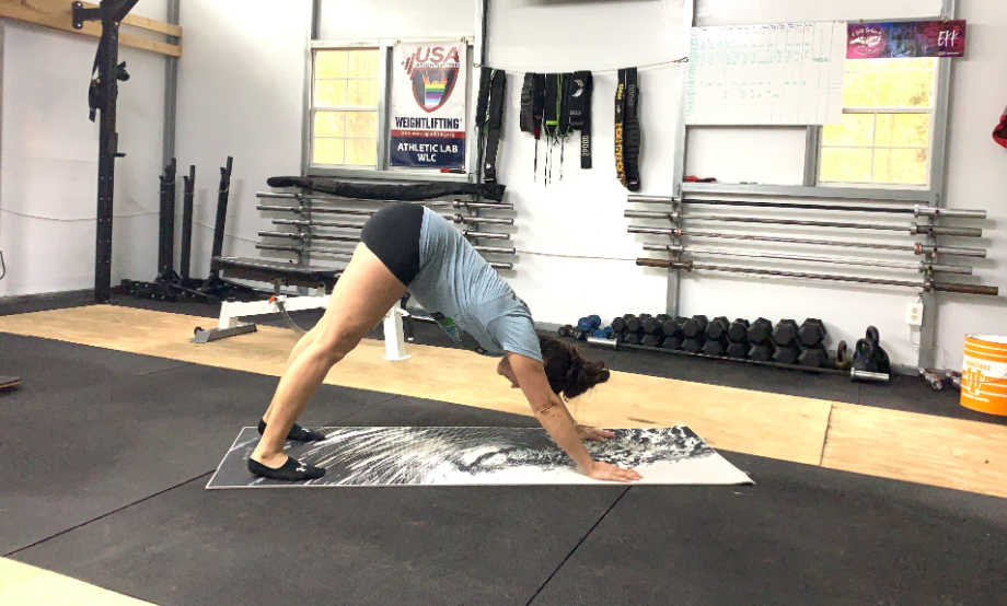 woman performing downward dog on gaiam yoga mat