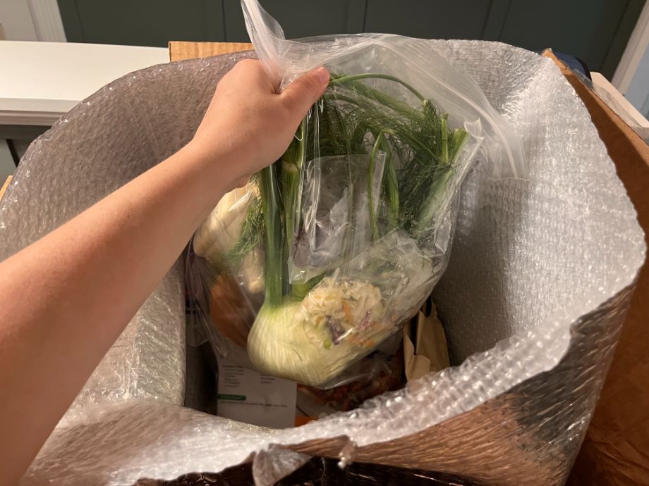 Photo showing hand pulling ingredients from a Gobble meal delivery box