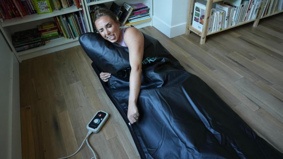 Woman using HigherDose infrared sauna blanket