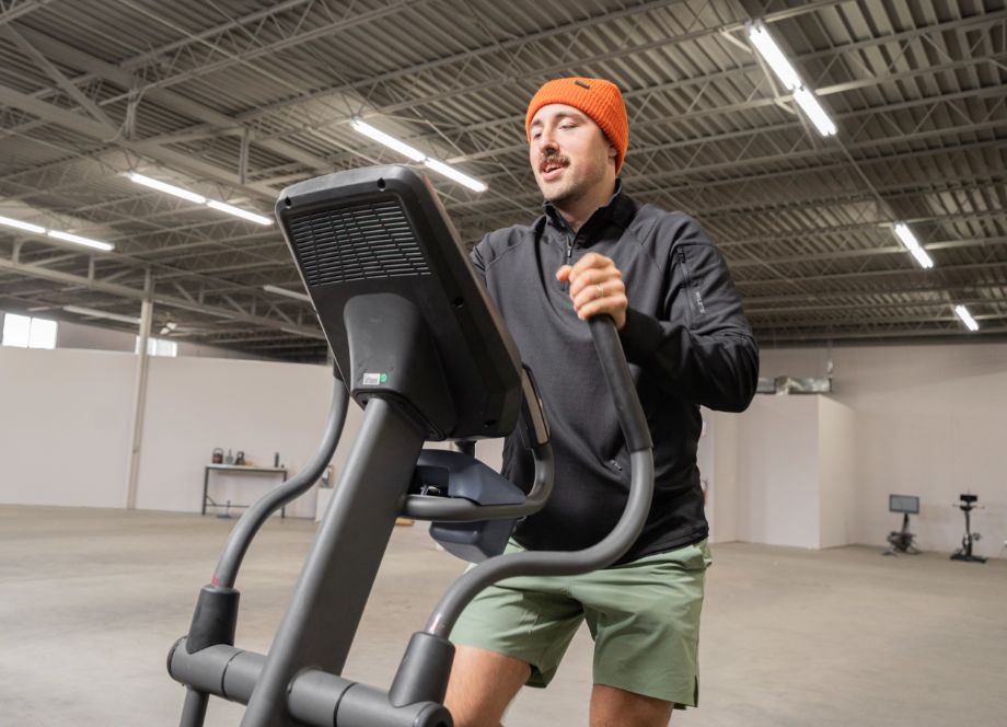 Coop on the elliptical with a beanie on.