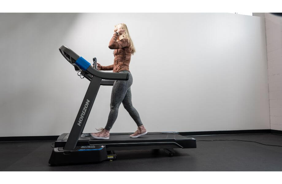 Woman walking on the Horizon 7.0 AT treadmill