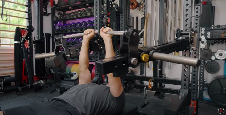 Man performing the bench press with jammer arms