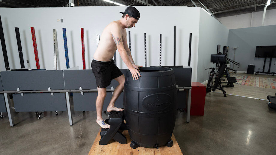 Man dipping into ice barrel