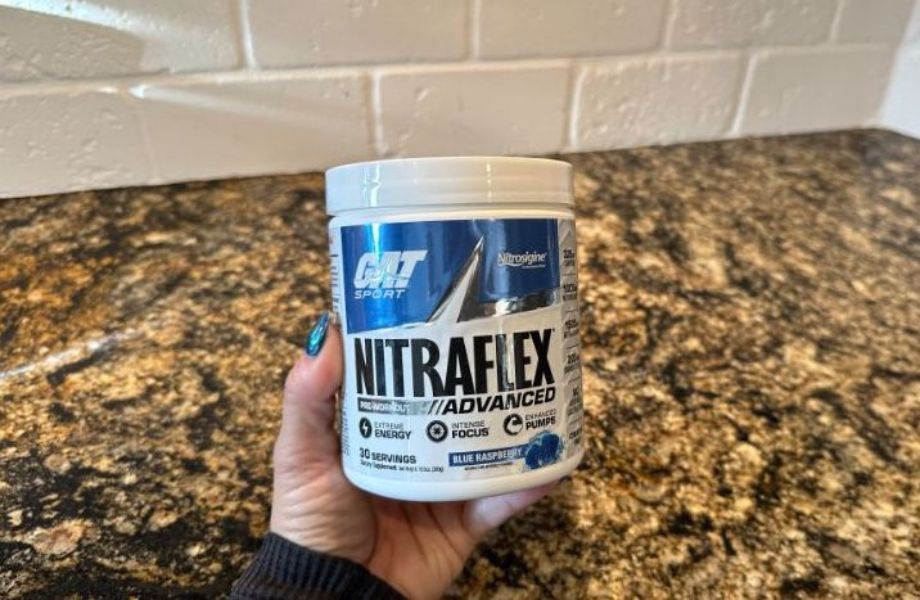 Hand holding Nitraflex Pre-Workout container