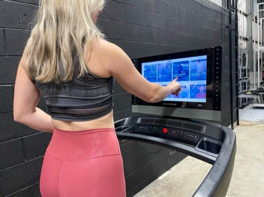 Caroline using the 22-inch touchscreen on the NordicTrack 2450.