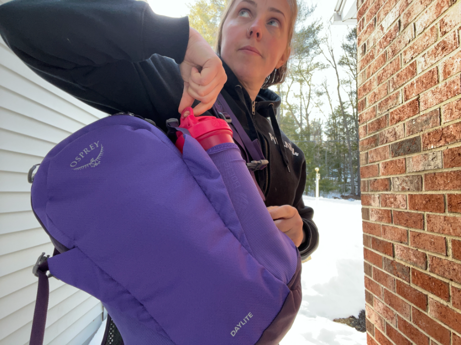 woman holding osprey backpack