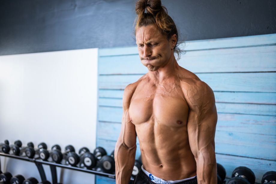 Image of a man doing dumbbell shrugs