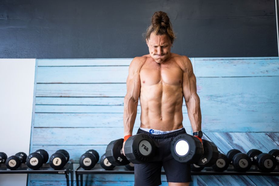 Image of a man doing dumbbell shrugs