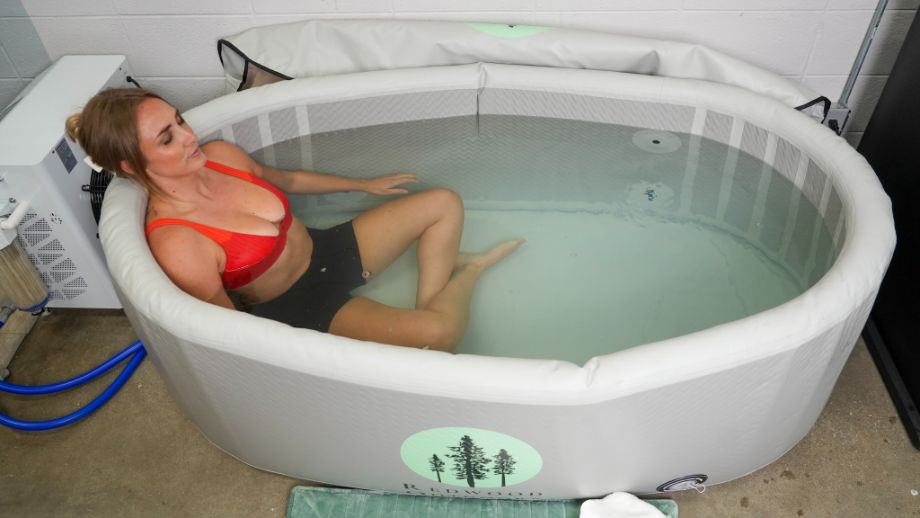 Woman sitting with legs crossed in the Redwood Outdoors Yukon tub