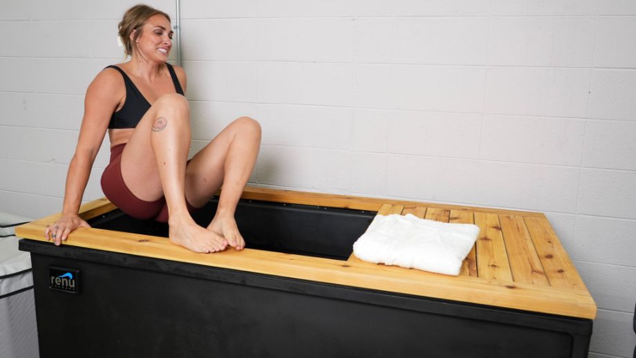 Woman getting in the Renu Therapy Cold Stoic tub
