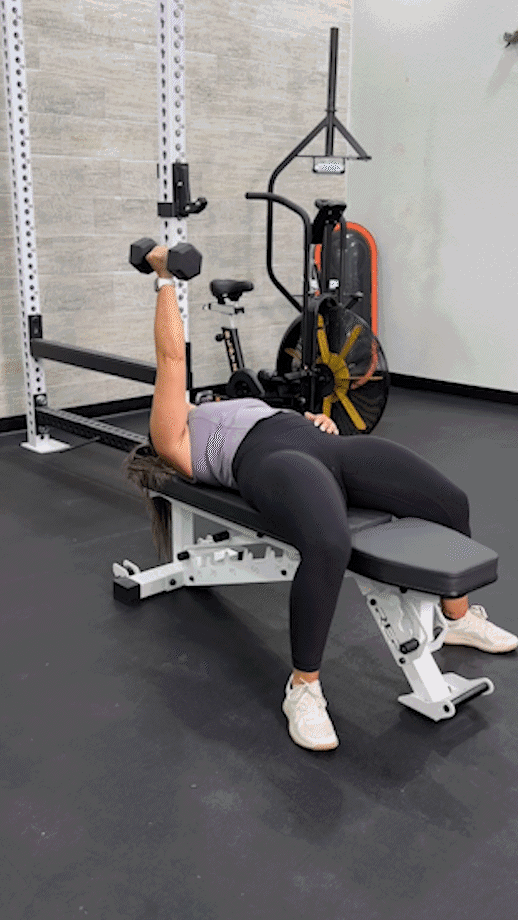 Woman doing a single-arm dumbbell fly