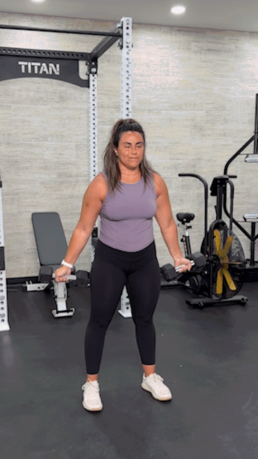 Woman doing a standing dumbbell fly